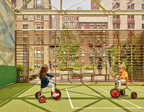 Photo of children on the rooftop playdeck of St. Hilda's & St. Hugh's School designed by MBB Architects