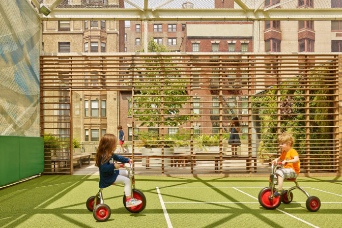 Photo of children on the rooftop playdeck of St. Hilda's & St. Hugh's School designed by MBB Architects