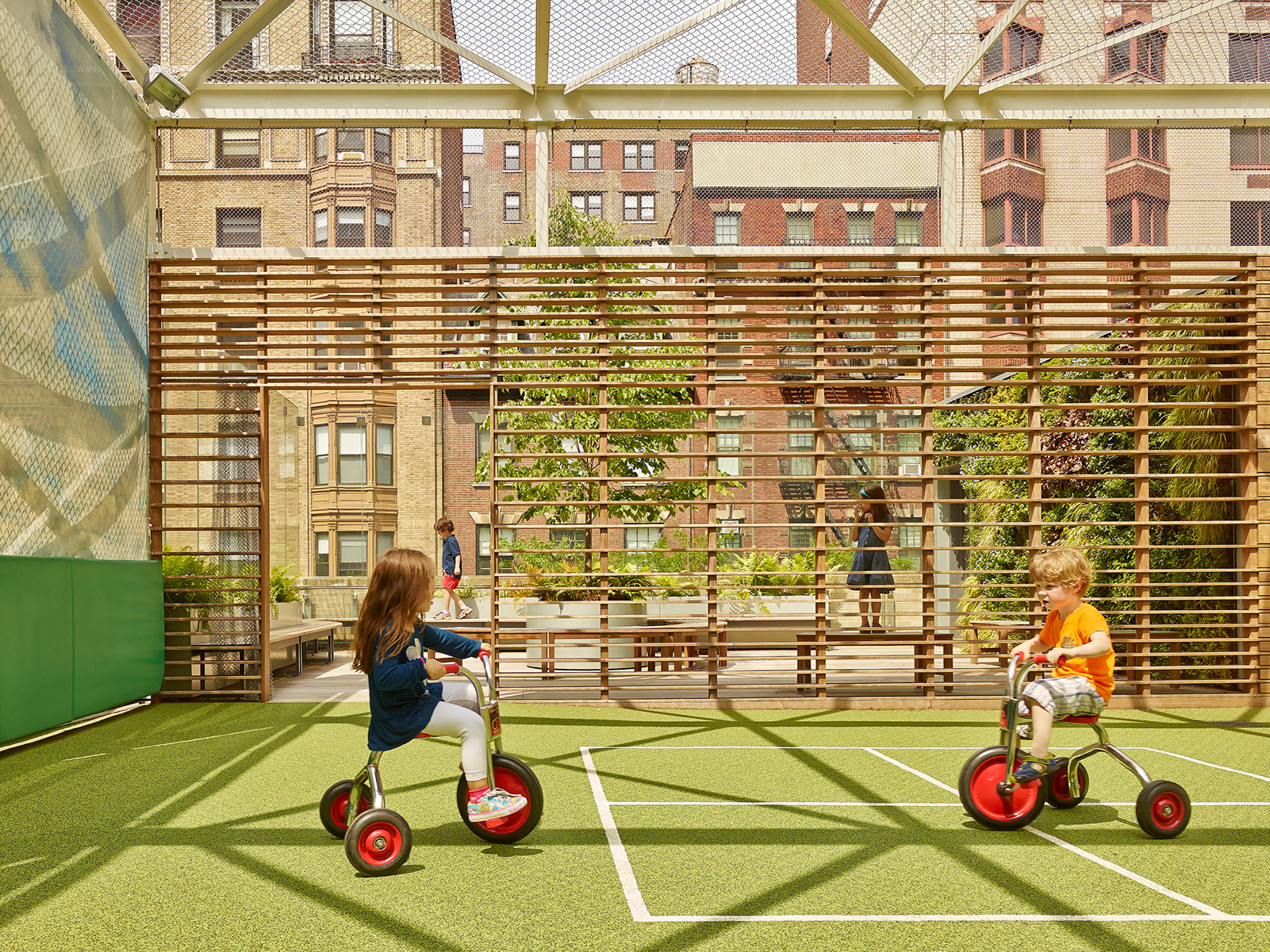 Photo of children on the rooftop playdeck of St. Hilda's & St. Hugh's School designed by MBB Architects