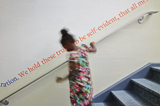 Photo of a student on a stairway in a school designed by MBB Architects