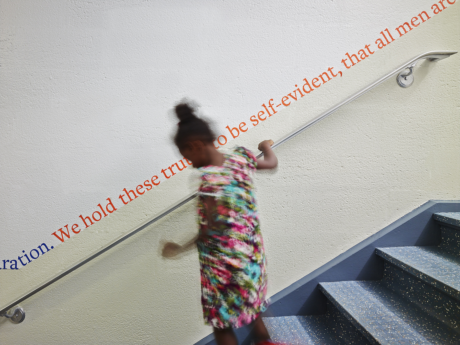 Photo of a student on a stairway in a school designed by MBB Architects